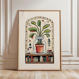 May include: Framed art print depicting a Venus flytrap in a glass jar, set against a cream backdrop. The illustration includes a terracotta pot, a bookshelf with books, and decorative elements. The artwork is in a wooden frame.