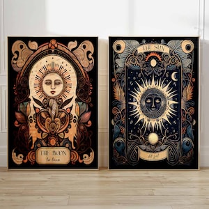 May include: Two framed prints with ornate borders depicting the sun and moon. The sun print features a yellow sun with a face and rays, with the text "THE SUN El Sol" in a banner below. The moon print features a white moon with a face and rays, with the text "THE MOON La Luna" in a banner below.