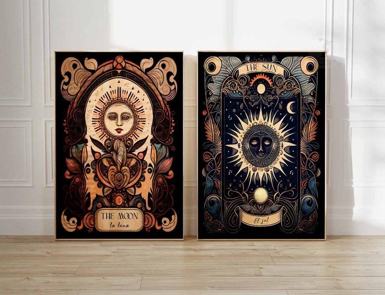 May include: Two framed prints with ornate borders depicting the sun and moon. The sun print features a yellow sun with a face and rays, with the text "THE SUN El Sol" in a banner below. The moon print features a white moon with a face and rays, with the text "THE MOON La Luna" in a banner below.