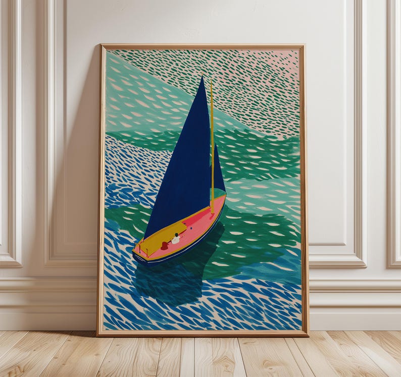 May include: A framed art print depicting a sailboat on water. The boat features a navy blue sail, a pink hull, and a yellow mast. The water is rendered in shades of blue and green, with a textured pattern. The artwork is displayed on a wooden floor.