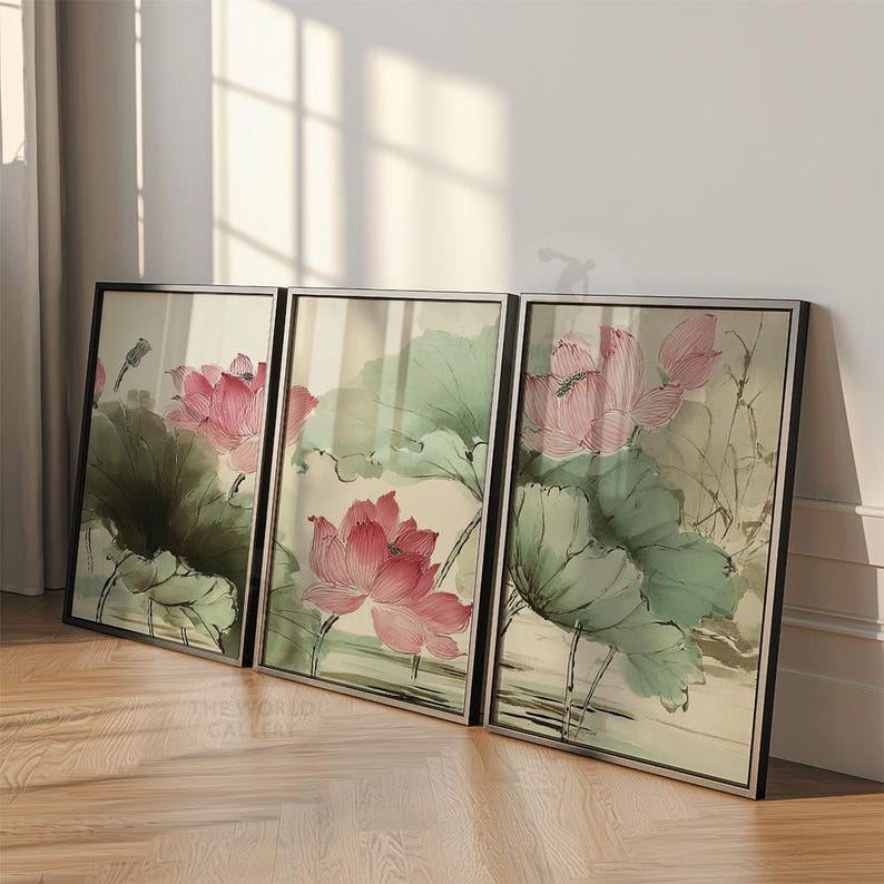 May include: Three framed art prints featuring watercolor paintings of pink lotus flowers and green leaves. The artwork has a traditional Asian style, with soft colors and delicate brushstrokes. The frames are black.