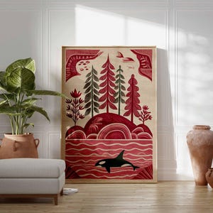 May include: A framed art print featuring a stylized landscape with red and green trees, a red ocean, and a black and white orca. The artwork has a beige background and is displayed in a room with a plant, ottoman, and decorative vases.