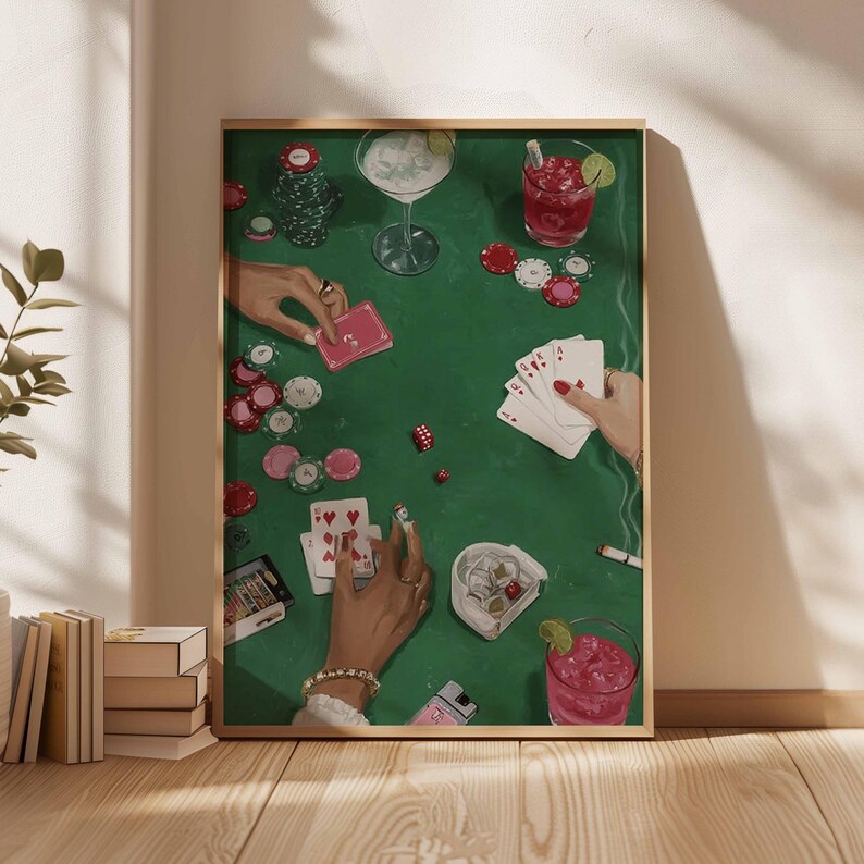 May include: A framed art print depicting a poker game scene. The artwork features a green felt table with playing cards, poker chips, dice, and cocktails. Hands with jewelry are visible, holding cards and chips. The overall color palette is green, red, and white.