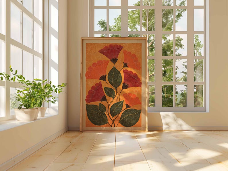 May include: A framed floral art print featuring stylized red and orange flowers with green leaves against a warm yellow background. The artwork is displayed on a light wood floor near a window, creating a bright and airy atmosphere.