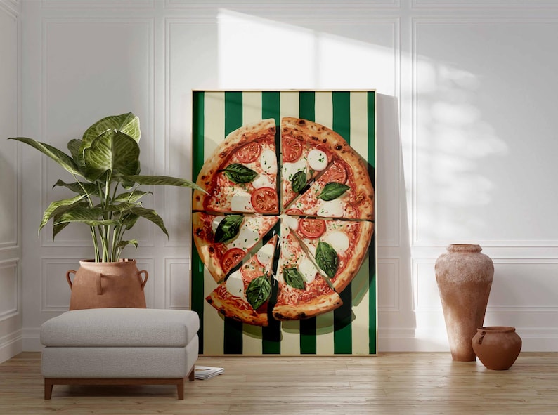 May include: A large framed pizza art print. The pizza is sliced and topped with tomatoes, mozzarella, and basil. The background is a green and cream striped pattern. The print is displayed in a room with a plant, ottoman, and decorative vases.