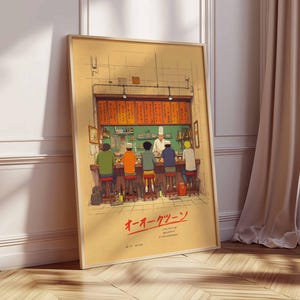 May include: Framed art print depicting a Japanese ramen shop scene. The illustration shows a chef behind a counter serving customers seated at a bar. The artwork features warm colors and Japanese text.