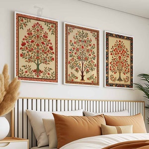 May include: Three framed floral prints with a white background and red, green, and yellow flowers. The prints are hung on a white wall above a bed with brown and white bedding.