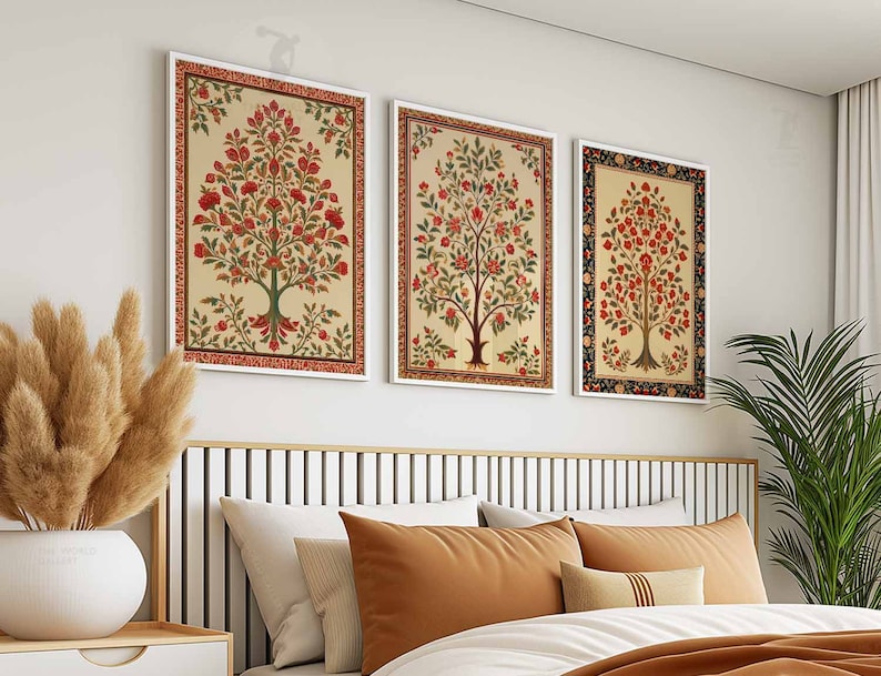 May include: Three framed floral prints with a white background and red, green, and yellow flowers. The prints are hung on a white wall above a bed with brown and white bedding.