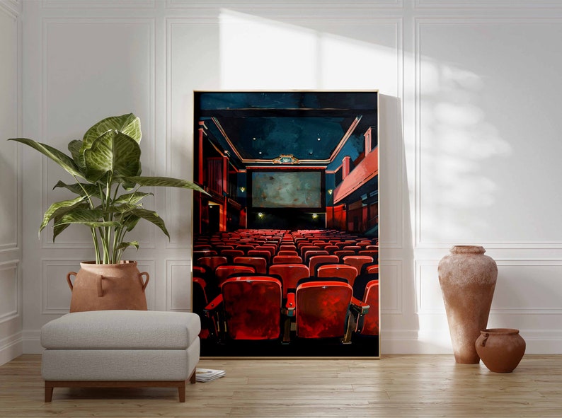 May include: A painting of a movie theater interior with red seats facing a large screen. The theater is empty and the screen is blank. The painting is framed in gold.