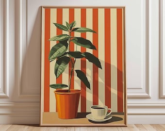 May include: A framed art print featuring a potted plant with large green leaves, set against a backdrop of orange and cream vertical stripes. A small white teacup and saucer sit on a table in front of the plant. The artwork is in a wooden frame.