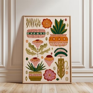 May include: A framed art print featuring a botanical illustration. The artwork showcases stylized flowers, plants, and decorative pots in shades of pink, orange, green, and brown against a cream background. The print is in a wooden frame.