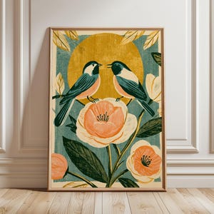 Puede incluir: Una impresión de arte mural rectangular que muestra dos carboneros cabecinegros posados sobre una gran flor de color naranja pálido. El fondo presenta un panel de color verde azulado texturizado con un gran círculo amarillo dorado, rodeado de hojas y capullos.