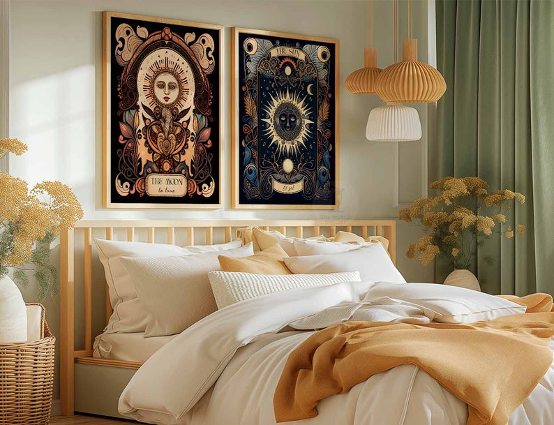 May include: Two framed illustrations of the sun and moon with intricate details and floral accents. The sun illustration features a face with a crown and the moon illustration features a crescent moon with stars. The frames are black and the illustrations are on a dark background.