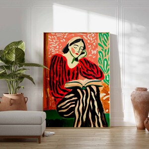May include: A painting of a person in a red and black striped shirt and pants sitting and reading a book. The background is a pink and green floral pattern.