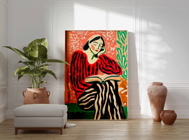 May include: A painting of a person in a red and black striped shirt and pants sitting and reading a book. The background is a pink and green floral pattern.
