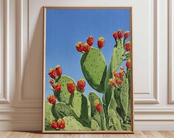 May include: A framed painting of a prickly pear cactus with bright green pads and vibrant red fruit against a clear blue sky. The artwork is displayed in a room with white wainscoting and a wooden floor.