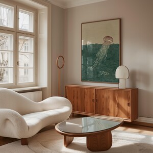 May include: A living room scene featuring a white, curved sofa, a wooden coffee table with a glass top, and a wooden cabinet. A large framed artwork depicts a jellyfish in the ocean. A white lamp and a wooden floor lamp are also present.