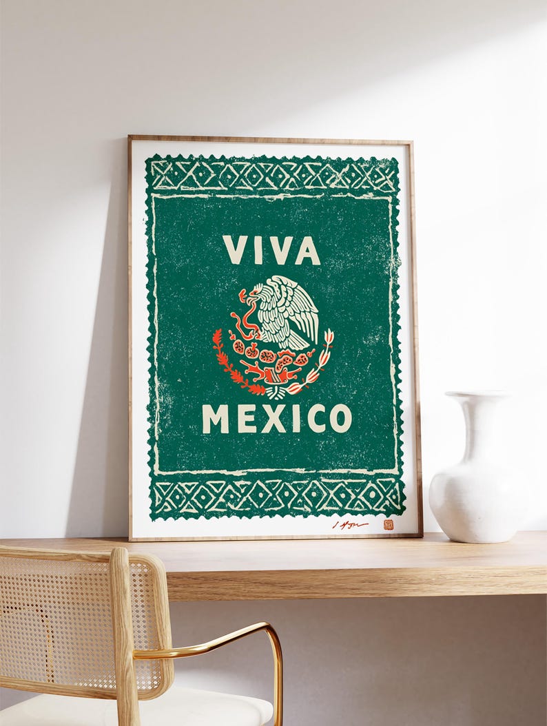 May include: Framed print featuring the Mexican coat of arms, with a green background and white text that reads "VIVA MEXICO." The artwork has a distressed, vintage aesthetic, with a wooden frame.