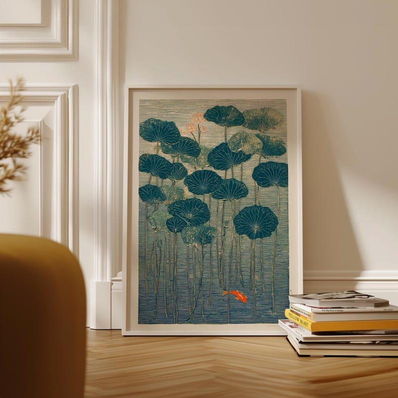 May include: Framed art print featuring a serene pond scene with teal lily pads and a vibrant orange koi fish. The artwork has a vintage aesthetic, with a textured appearance and a soft color palette. The print is displayed in a white frame.