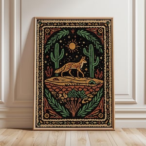 May include: Framed art print featuring a desert landscape with a fox, cacti, and sun. The artwork has a vintage, folk art style with a black background and earth-tone colors. The print is in a wooden frame.