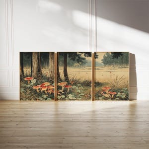 May include: Three framed art prints showing a forest landscape with trees, grass, and red mushrooms. The artwork has a vintage style with muted colours and gold frames. Each frame measures approximately 50 cm.