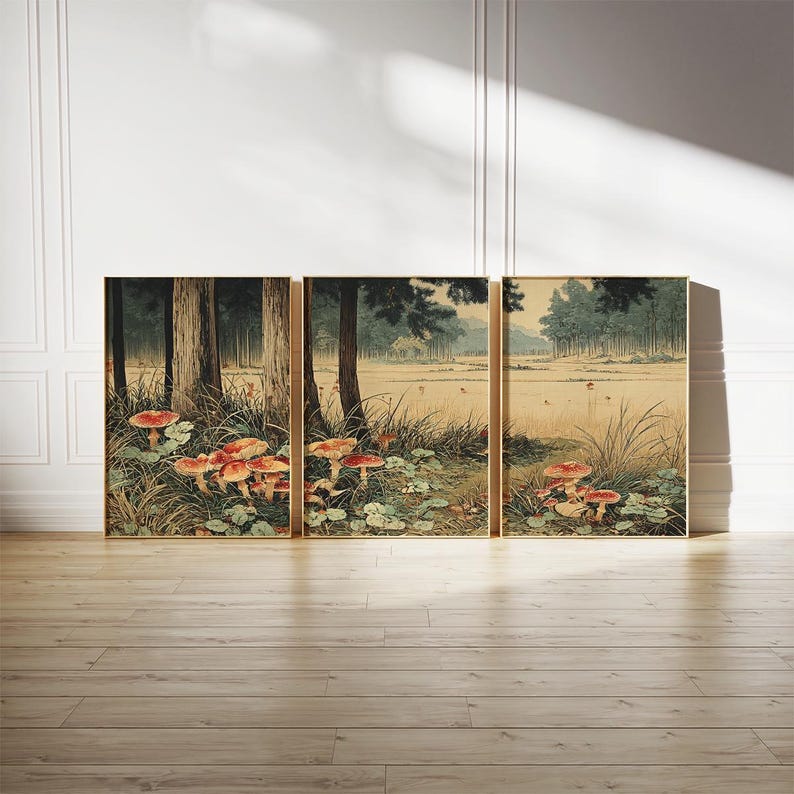 May include: Three framed art prints showing a forest landscape with trees, grass, and red mushrooms. The artwork has a vintage style with muted colours and gold frames. Each frame measures approximately 50 cm.