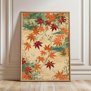 May include: A rectangular wall art print featuring a pattern of vibrant orange and deep red maple leaves scattered across a light cream background with subtle teal and green brushstroke accents, all enclosed in a simple wooden frame.