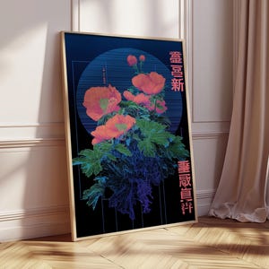May include: Framed art print featuring a floral design with orange flowers and green leaves against a dark blue background. The artwork includes Japanese text in pink and a circular design element. The frame is a light brown color.