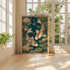 May include: Framed art print featuring two koi fish swimming in a pond with lily pads and lotus flowers. The fish are white with orange and black markings. The background is a dark teal color. Japanese characters are at the top.