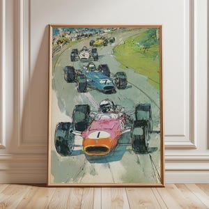 May include: A framed vintage racing art print. The artwork depicts a race with several formula race cars in action on a track. The lead car is pink with an orange nose and the number 1. The other cars are blue and yellow.
