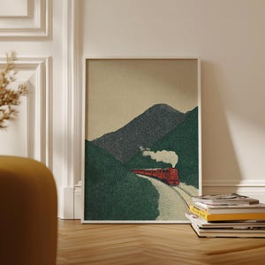 Peut inclure: Une affiche encadrée représentant un train rouge serpentant à travers un col de montagne. L'œuvre d'art présente une illustration en pointillé avec des collines vertes, une montagne grise et un ciel beige. Le train émet de la fumée blanche.