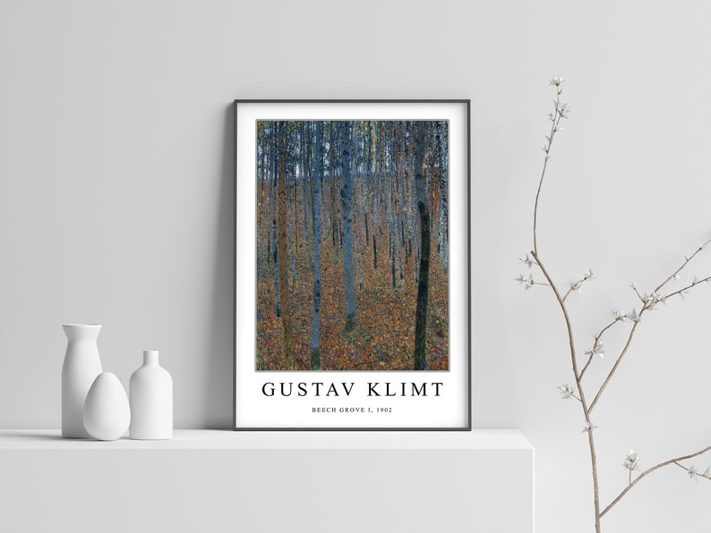 May include: A black framed poster featuring a painting by Gustav Klimt titled "Beech Grove I, 1902". The painting depicts a forest scene with tall, slender trees in shades of blue and green, with a ground covered in fallen leaves in shades of brown and yellow.