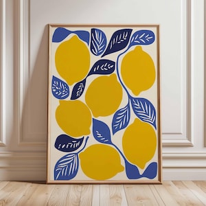 May include: A framed art print featuring a vibrant lemon design. The artwork showcases bright yellow lemons and deep blue leaves against a cream background. The print is encased in a wooden frame, adding a touch of warmth to the botanical theme.