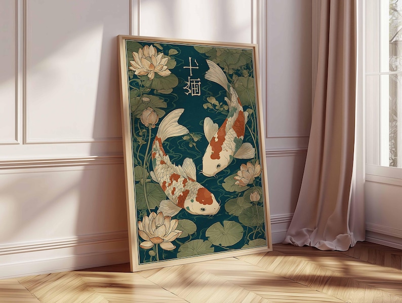 May include: Framed art print featuring two koi fish swimming among water lilies. The fish have white bodies with orange and red markings. The background is a deep teal color, and the artwork is in a wooden frame.