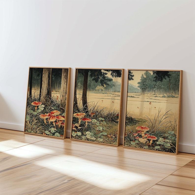 May include: Three framed art prints depicting a tranquil forest landscape. The prints display tall trees, verdant foliage, and striking red-topped mushrooms. The artwork has a vintage style with a natural colour palette, perfect for home decor.