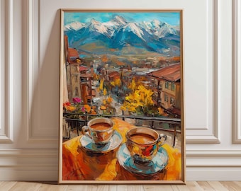 May include: A framed oil painting depicts a scenic view of a mountain range and a town. Two cups of coffee sit on a table in the foreground. The artwork features vibrant colors, including blues, oranges, and greens, creating a warm and inviting atmosphere.