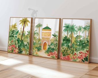 May include: Set of three framed watercolor prints depicting a lush tropical scene. The artwork features palm trees, vibrant green foliage, and red flowers. One print showcases a building with an arched doorway and a green roof.
