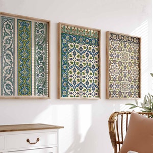 May include: Three framed prints with intricate geometric patterns in shades of blue, green, and yellow. The frames are made of wood and have a light brown finish.
