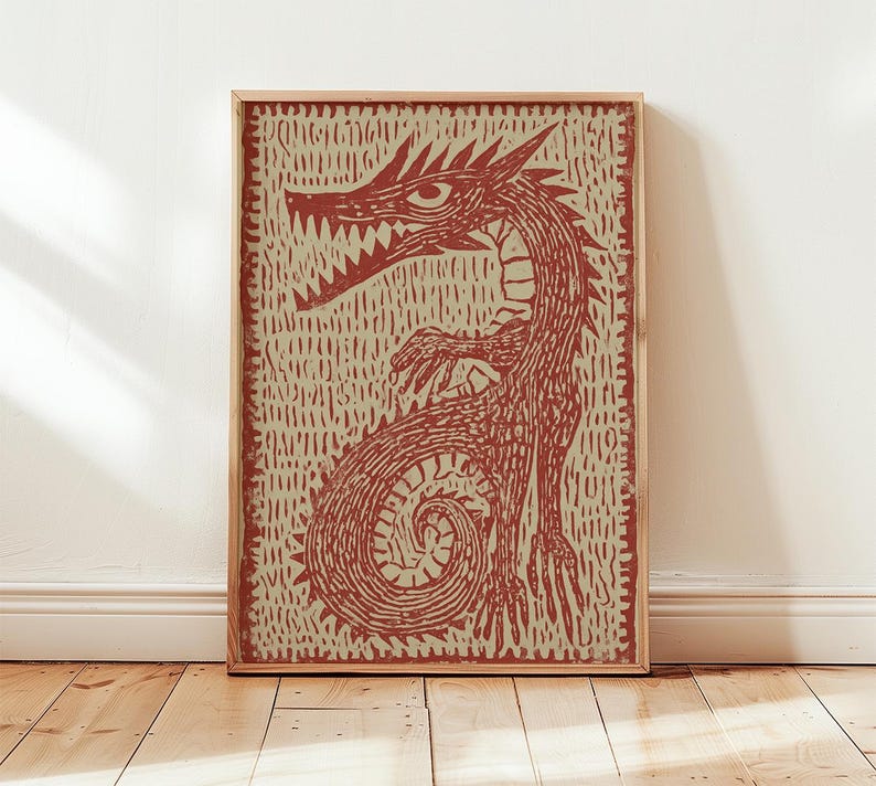 May include: A framed print featuring a stylized red dragon illustration. The dragon is depicted with sharp teeth, claws, and a curled tail, set against a textured beige background. The artwork is enclosed in a natural wood frame, suitable for wall decor.