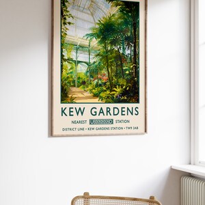 May include: Vintage travel poster for Kew Gardens in London, England. The poster features a colorful illustration of a greenhouse with lush tropical plants. The text reads "Kew Gardens" and "Nearest Underground Station District Line - Kew Gardens Station - TW9 3AB".