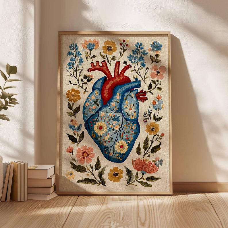 May include: A framed art print featuring a stylized anatomical heart illustration. The heart is blue with floral patterns and red details, surrounded by colorful flowers and foliage. The artwork is in a wooden frame, creating a decorative piece.