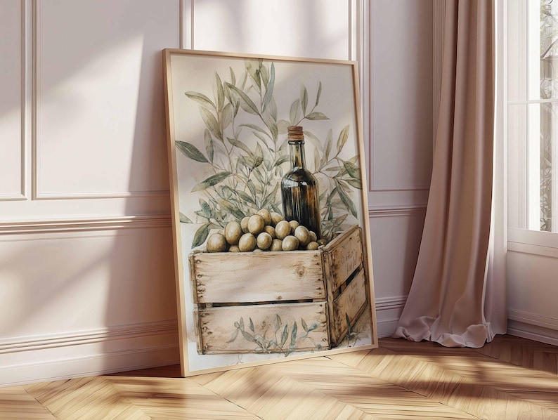 May include: Watercolor print of a still life featuring a wooden crate filled with olives, a dark glass bottle, and olive branches. The artwork has a neutral color palette with a rustic aesthetic, perfect for kitchen or dining room decor.