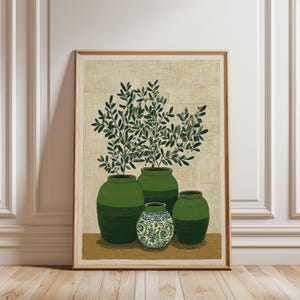 May include: A framed art print featuring four green vases, each with a unique shape and design. The vases hold leafy green plants against a beige textured background. The smallest vase has a blue and white floral pattern.