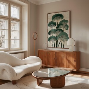 May include: A living room scene featuring a cream-colored, curved sofa, a wooden coffee table with a glass top, and a wooden cabinet. A framed artwork with green mushroom illustrations hangs on the wall, complemented by a modern lamp.