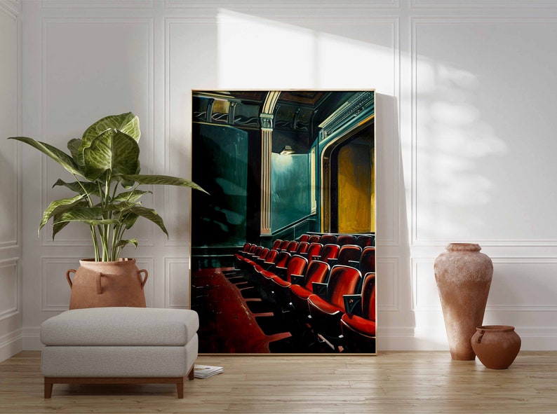 May include: A painting of a theater interior with rows of red seats. The seats are empty and the stage is dark. The painting is framed in gold.