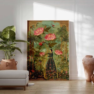 May include: A framed art print featuring a woman in a garden with large pink lotus flowers. The artwork has a vintage aesthetic with a green and gold color palette. A large potted plant and a gray ottoman are in the foreground.