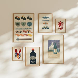 May include: A gallery wall set of six framed prints featuring Japanese culinary themes. The collection includes illustrations of sushi rolls, nigiri, a red fish, a lobster, a bottle labelled LIGHT SOY SAUCE, and a chef behind a counter.