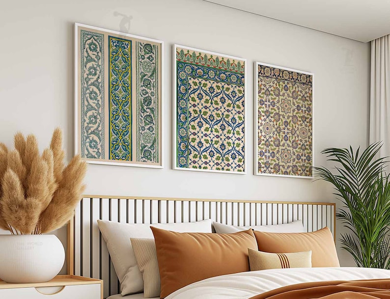May include: Three framed prints of intricate floral patterns in shades of blue, green, and brown. The prints are hung on a white wall above a bed with a brown headboard.