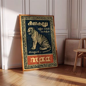 May include: A framed vintage-style poster featuring a tiger illustration. The tiger is depicted in gold against a dark blue background, with text in a foreign language. The frame is a warm brown color, and the poster is leaning against a white wall.