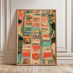 May include: A framed art print featuring a high-angle illustration of rows of vinyl records in bins. The artwork uses a textured, painterly style with a palette of orange, red, teal, and cream. Several figures are visible browsing the records.
